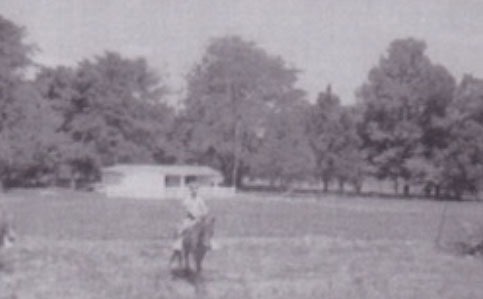 One of Dr. Nurnberger’s grandsons riding his pony in front of the barn built by Dr. Nurnberger.  The Webb cemetery is among the trees to the left of the barn.   Circa Nov. 1967.6