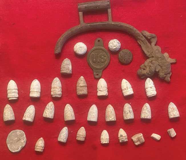 Germantown relic hunter, Sid Witherington, found these artifacts on the site of the Germantown Baptist Church. Above you will find the following: Melted brass Cavalry Stirrup, Eagle Uniform Button, U.S. Bit Boss Rosette, & Bullets- 2 .69 musket balls, 1 Burnside, 7 Sharps, 9 Cosmopolitan, 5 .44 Colt Pistol, 1 Flattened bullet (poker chip), & 3 Cut bullets