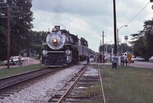 Train running west to Memphis (the 1970s) crossing North Street access to Poplar Pike.  The photo illustrates two parallel tracks.